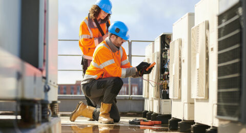 Two people performing maintenance and accessing keys through an electronic key storage and management system